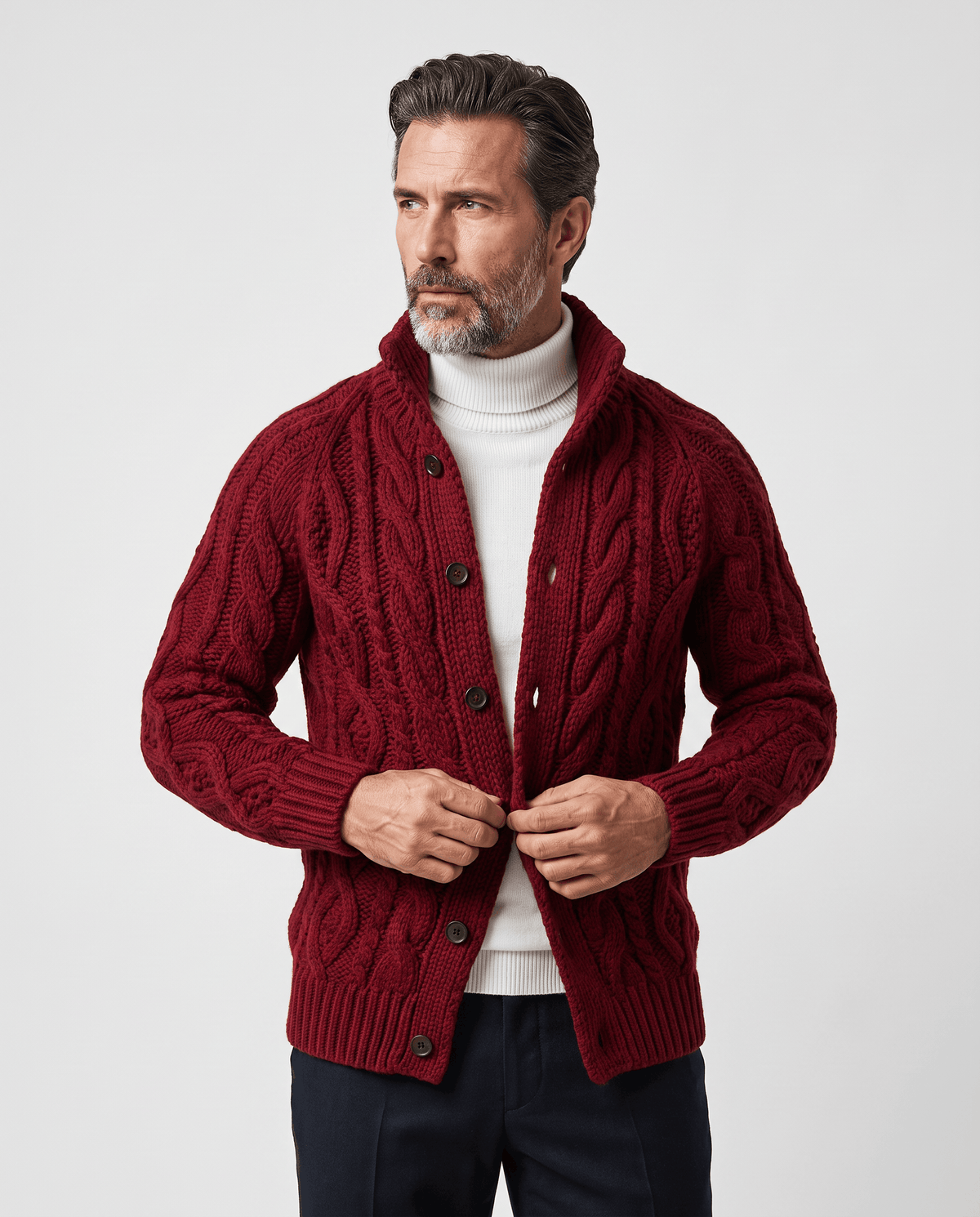 Men's red cable knit cardigan with button front worn over a white turtleneck