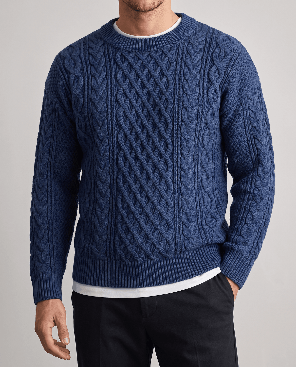 Front detail of blue chunky knit showing center diamond panel and ribbed hem