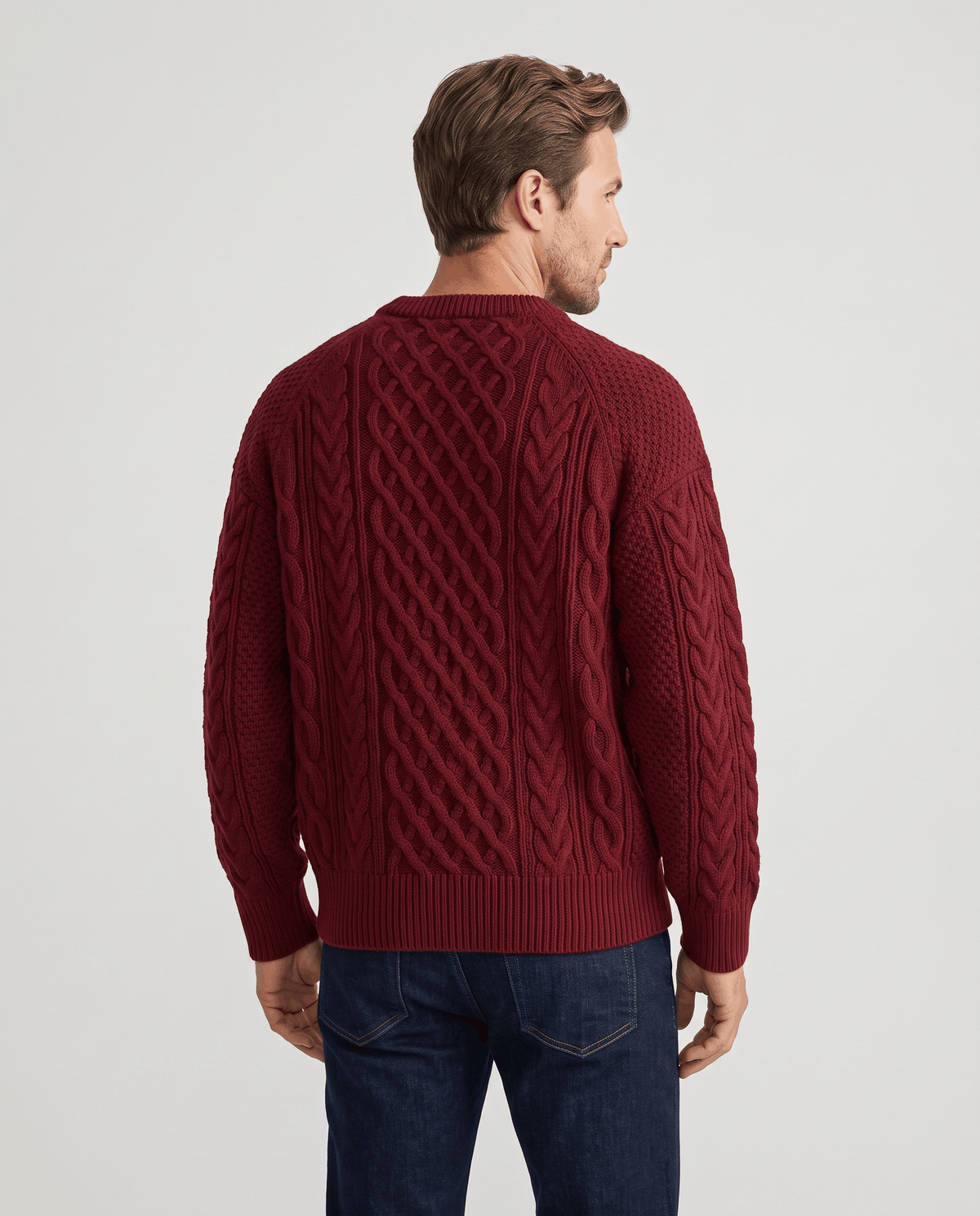 Back view of burgundy knit pullover with diamond cables and ribbed hem
