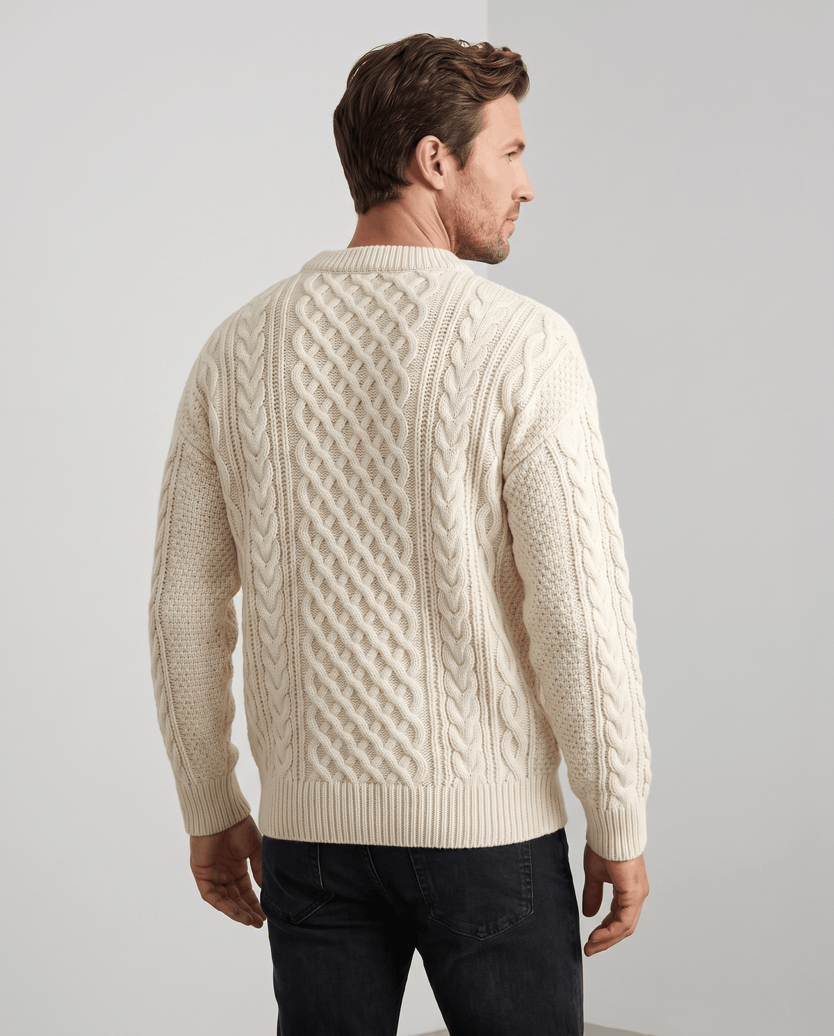 Back view of cream knit pullover showing diamond lattice and ribbed hem