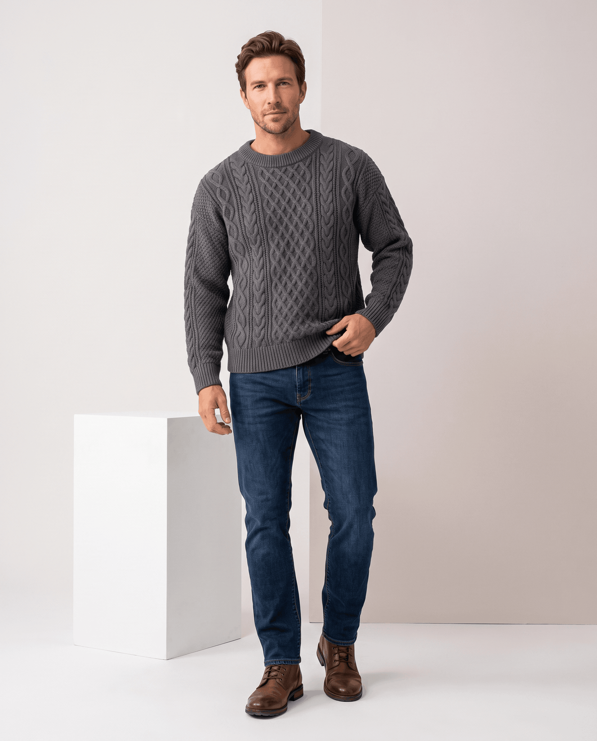 Full-length charcoal gray sweater outfit with blue jeans and brown leather boots