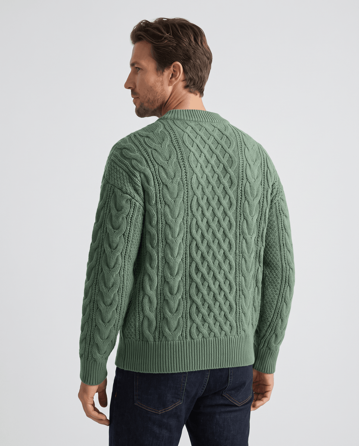 Back of sage green cable pullover showing full diamond lattice and ribbed cuffs