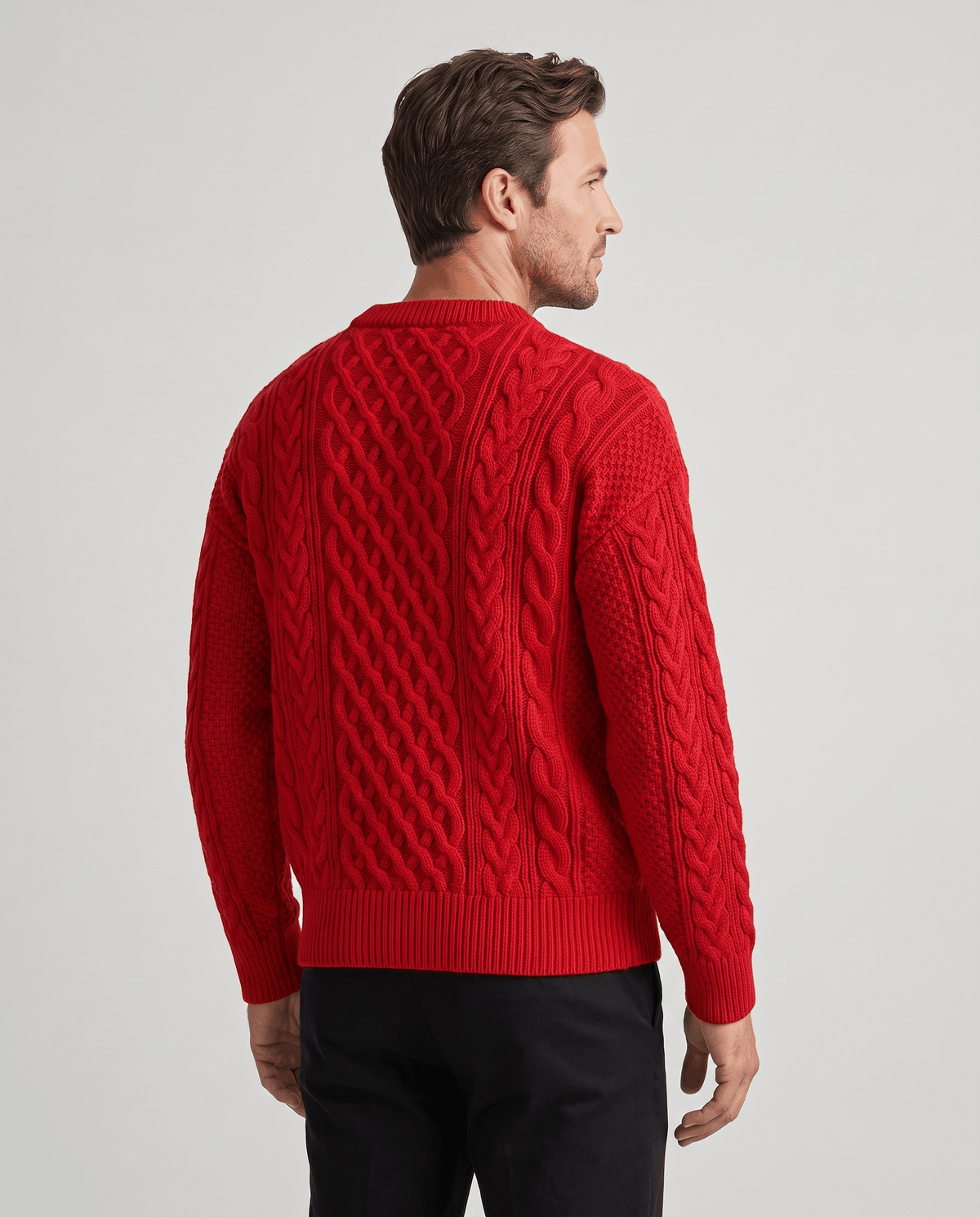 Back view of bright red crew neck pullover showing cable columns