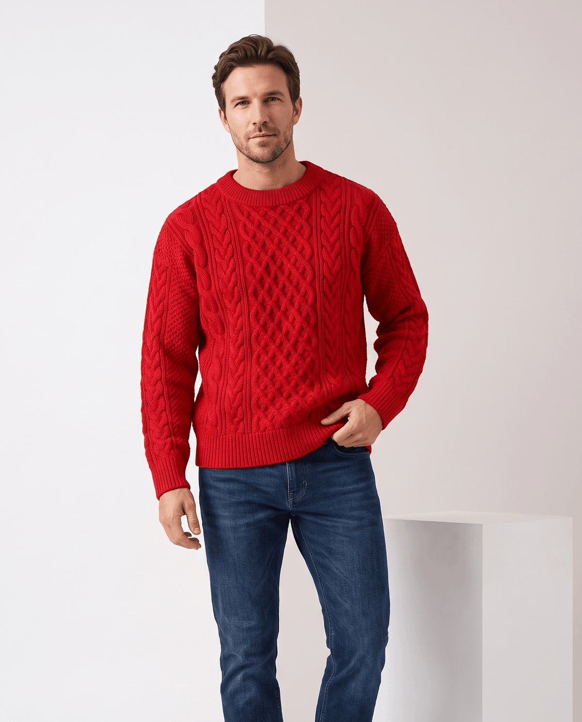 Model in bright red cable sweater with blue jeans, hand in pocket