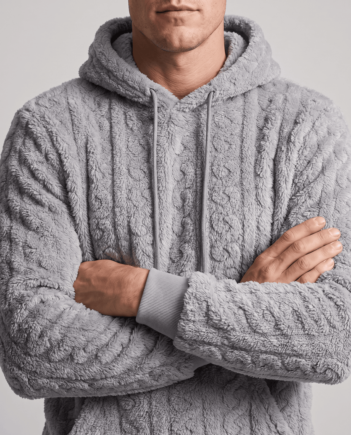 Gray hoodie with arms crossed, showing the chunky cable pattern and ribbed cuffs