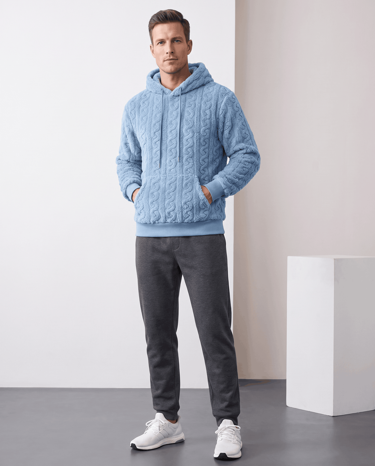 Full-length view of light blue hoodie styled with gray pants and white sneakers