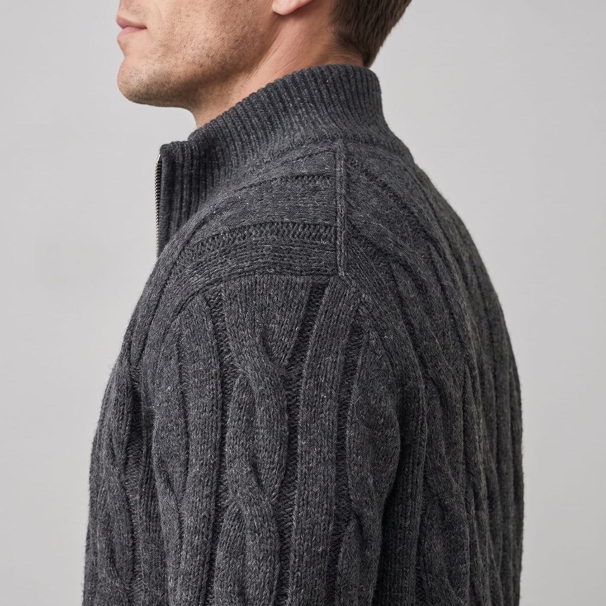 Side close-up of the gray cable knit texture and ribbed collar