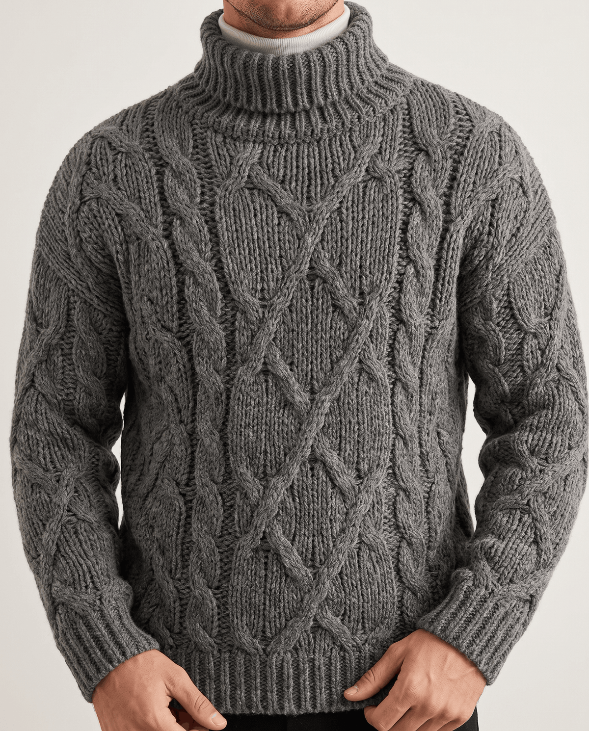 Front detail of heather gray chunky knit with diamond cables and ribbed waistband