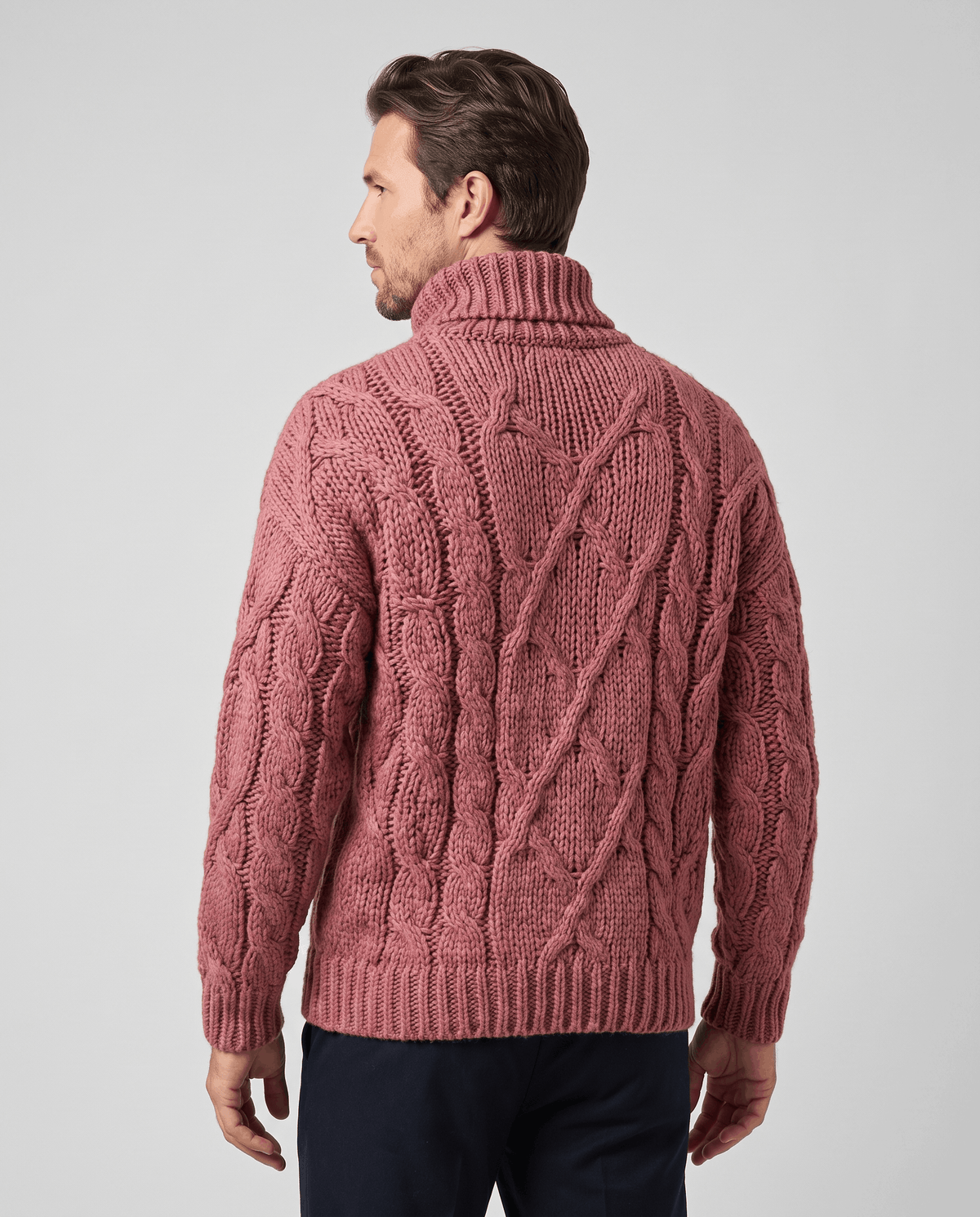 Back view of dusty pink chunky sweater showing diamond cable pattern and ribbed hem