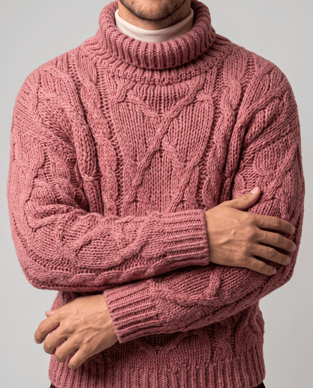 Dusty pink chunky knit front detail with arms folded showing ribbed cuffs and hem