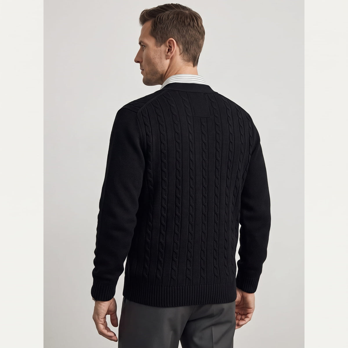 Back view of the black cable knit cardigan with ribbed hem