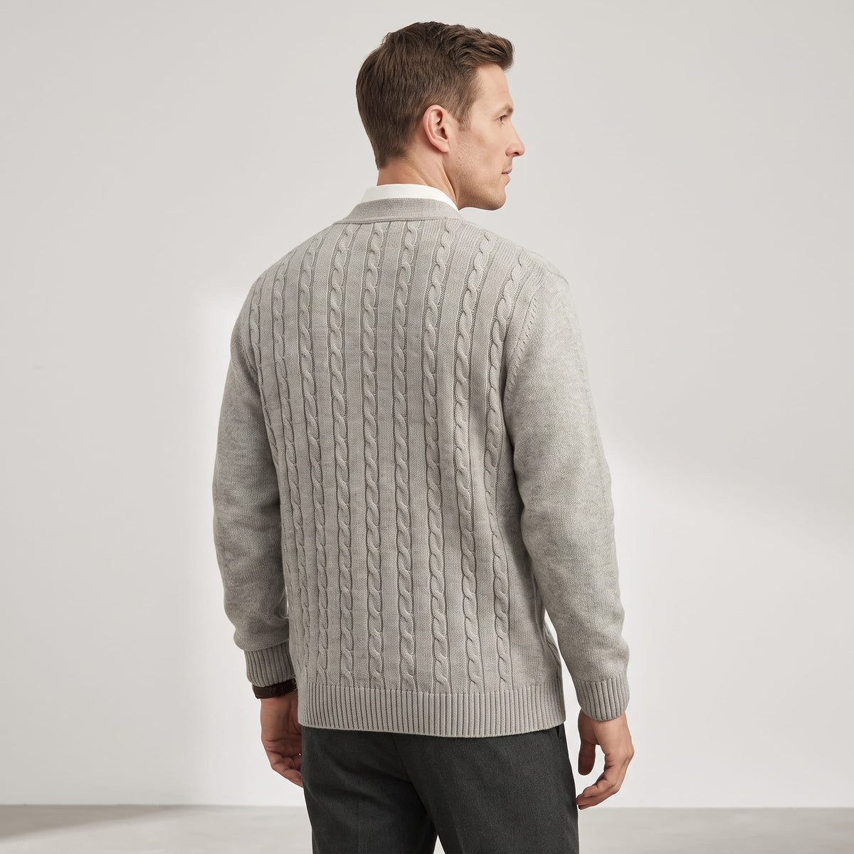 Back view of the gray cable knit cardigan with charcoal trousers