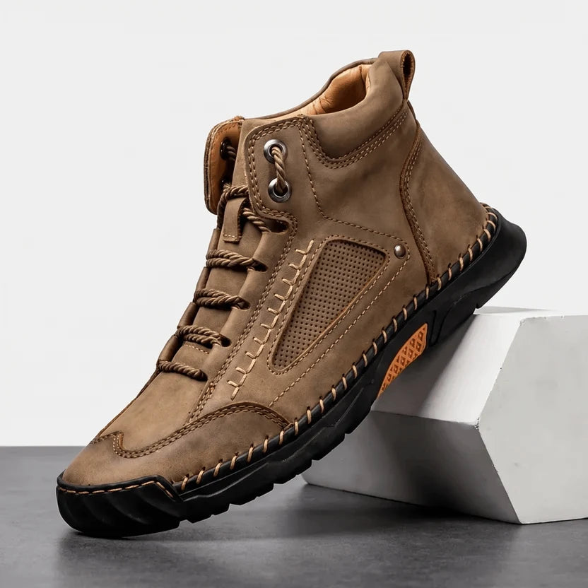 Camel wide toe box hiking boot angled on a white block showing the lug sole