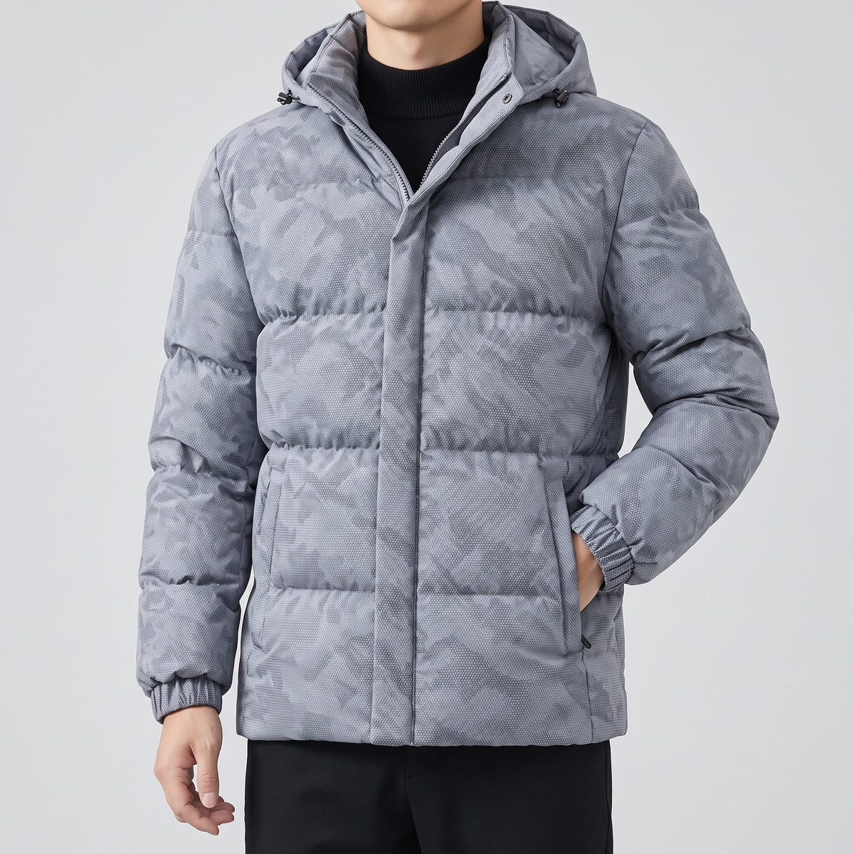 Light gray jacket worn zipped with hood down, side pockets at the hip