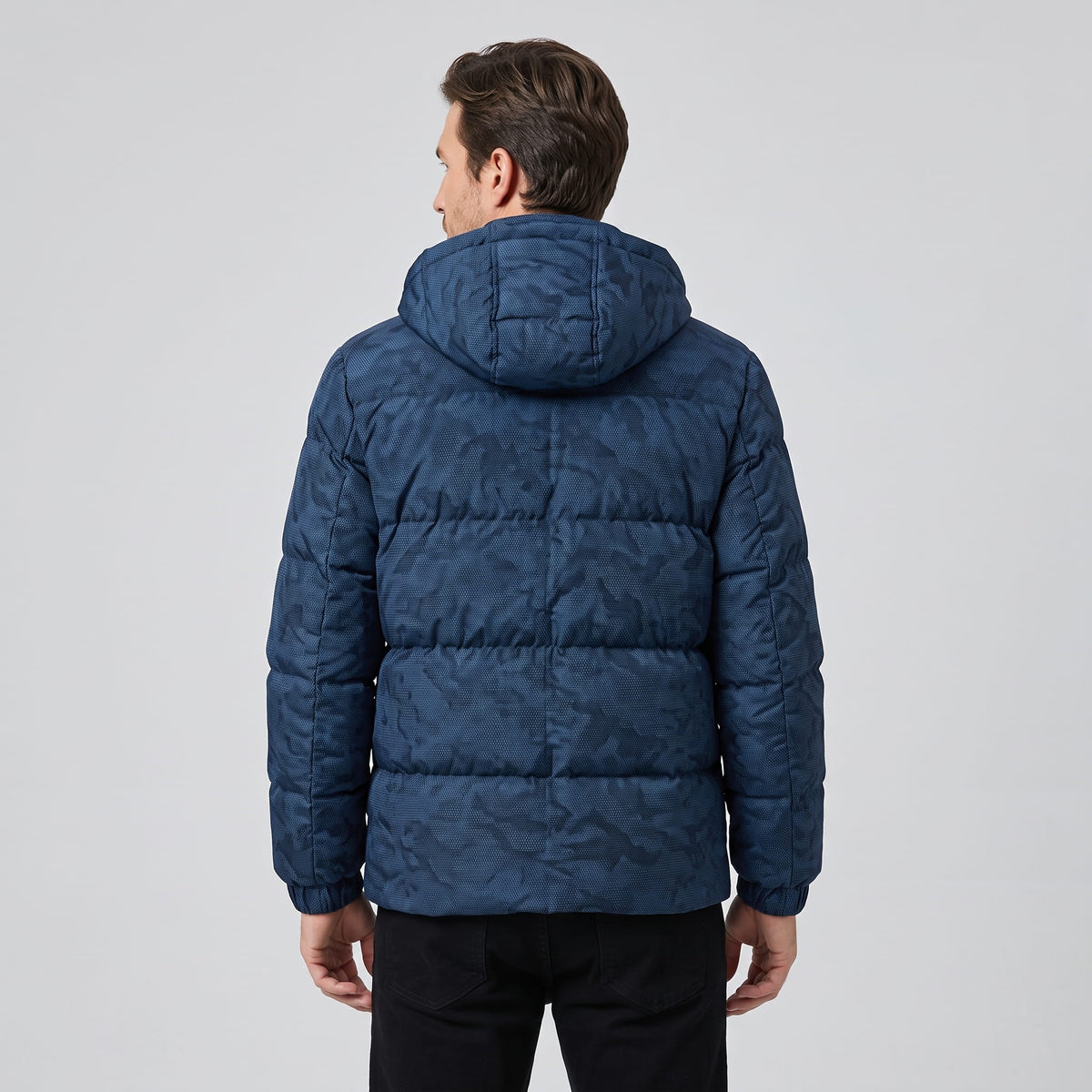 Rear view in navy showing hood shape, quilted blocks and hip-length hem