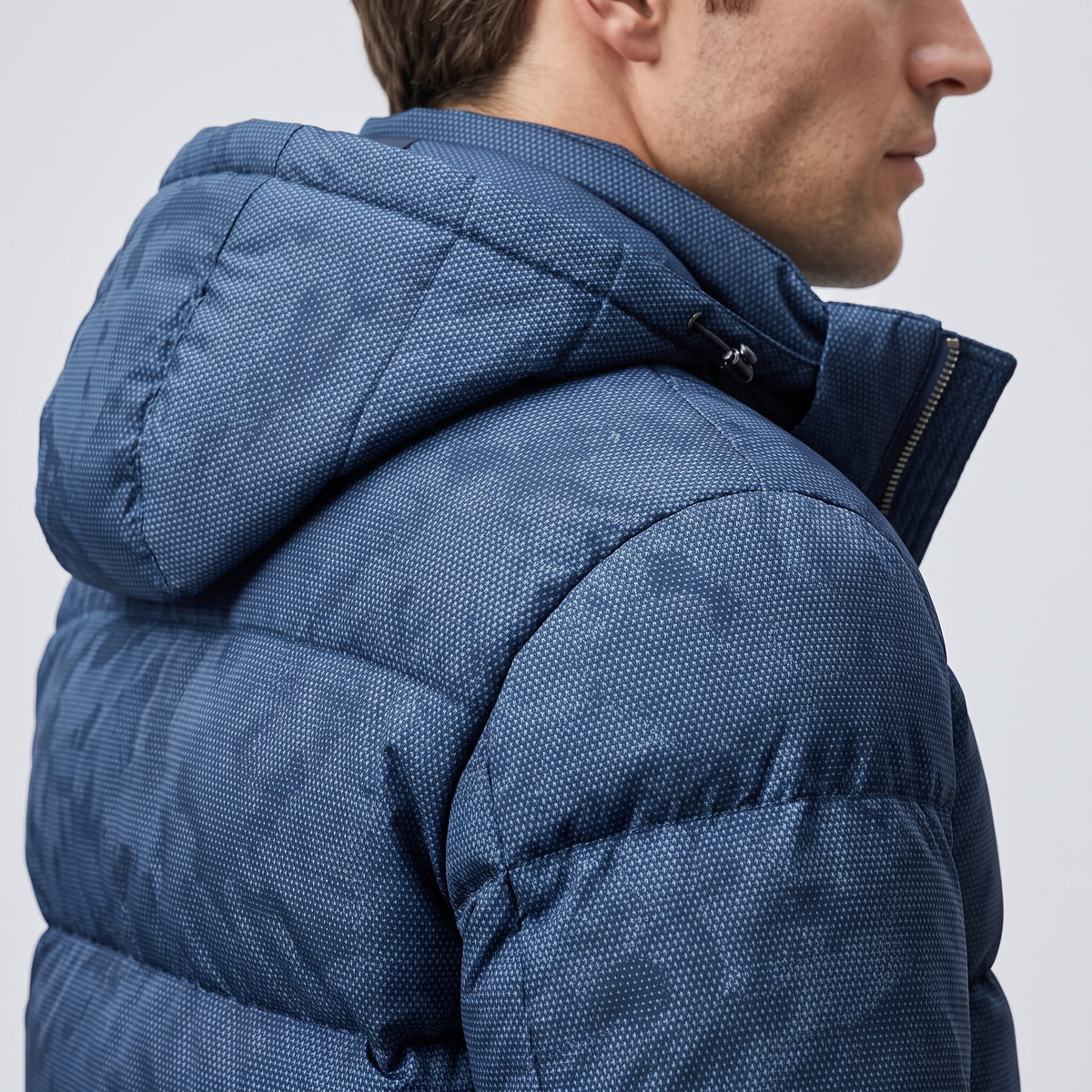 Detail of the navy hood and collar seam, showing the print at close range