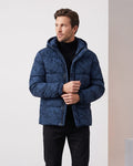 Navy jacket worn open, hand at the placket, hood behind the collar