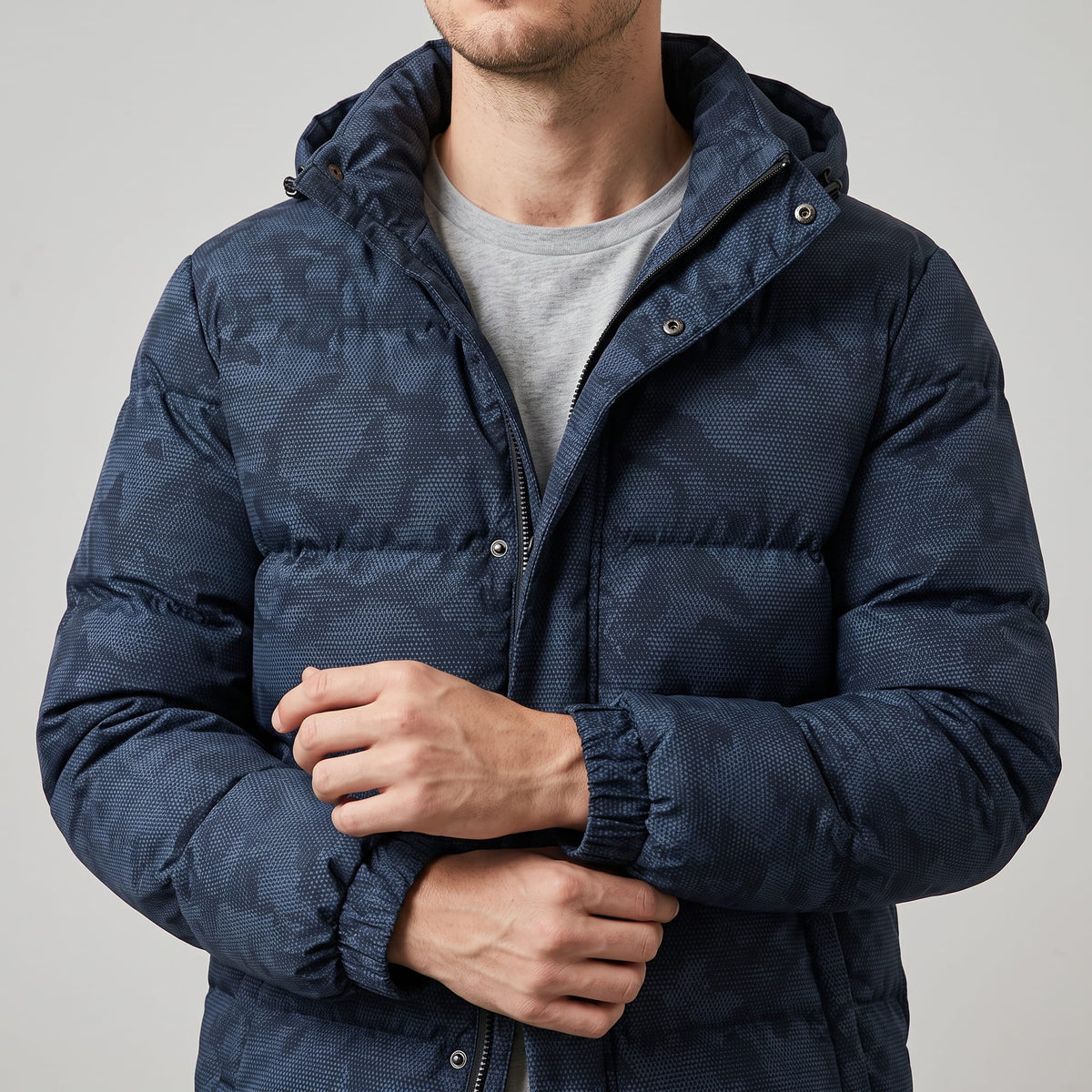 Navy jacket torso showing the snap placket over the zip and elastic cuffs
