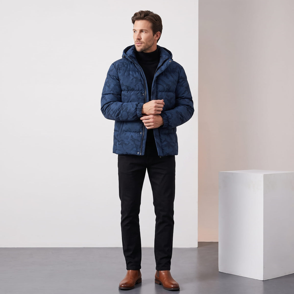 Navy jacket styled full-length with dark jeans and tan leather boots