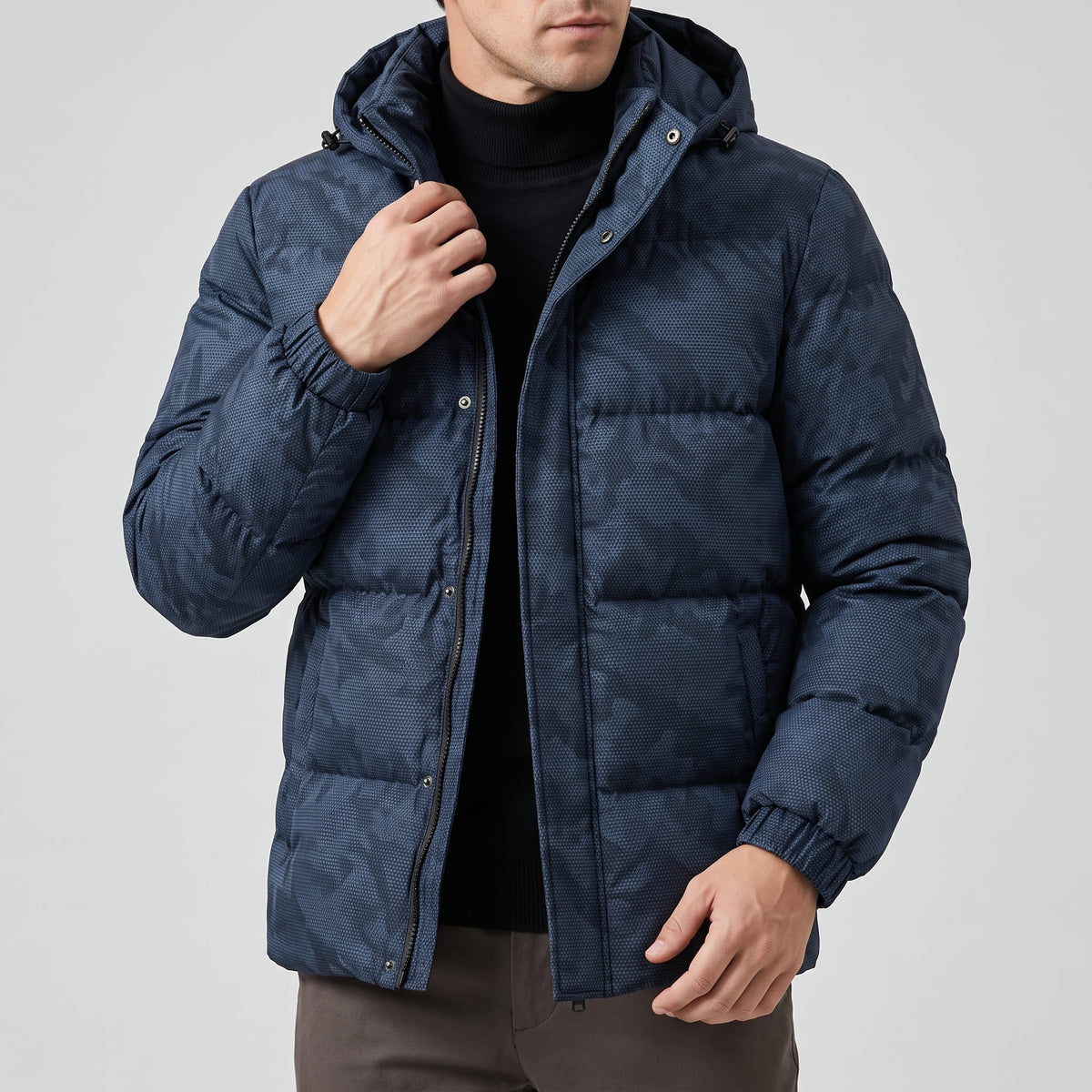 Navy jacket zipped to the chest, hood resting behind the raised collar