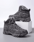 Men's camo winter hiking boots in black camo with fleece collar, on a white block