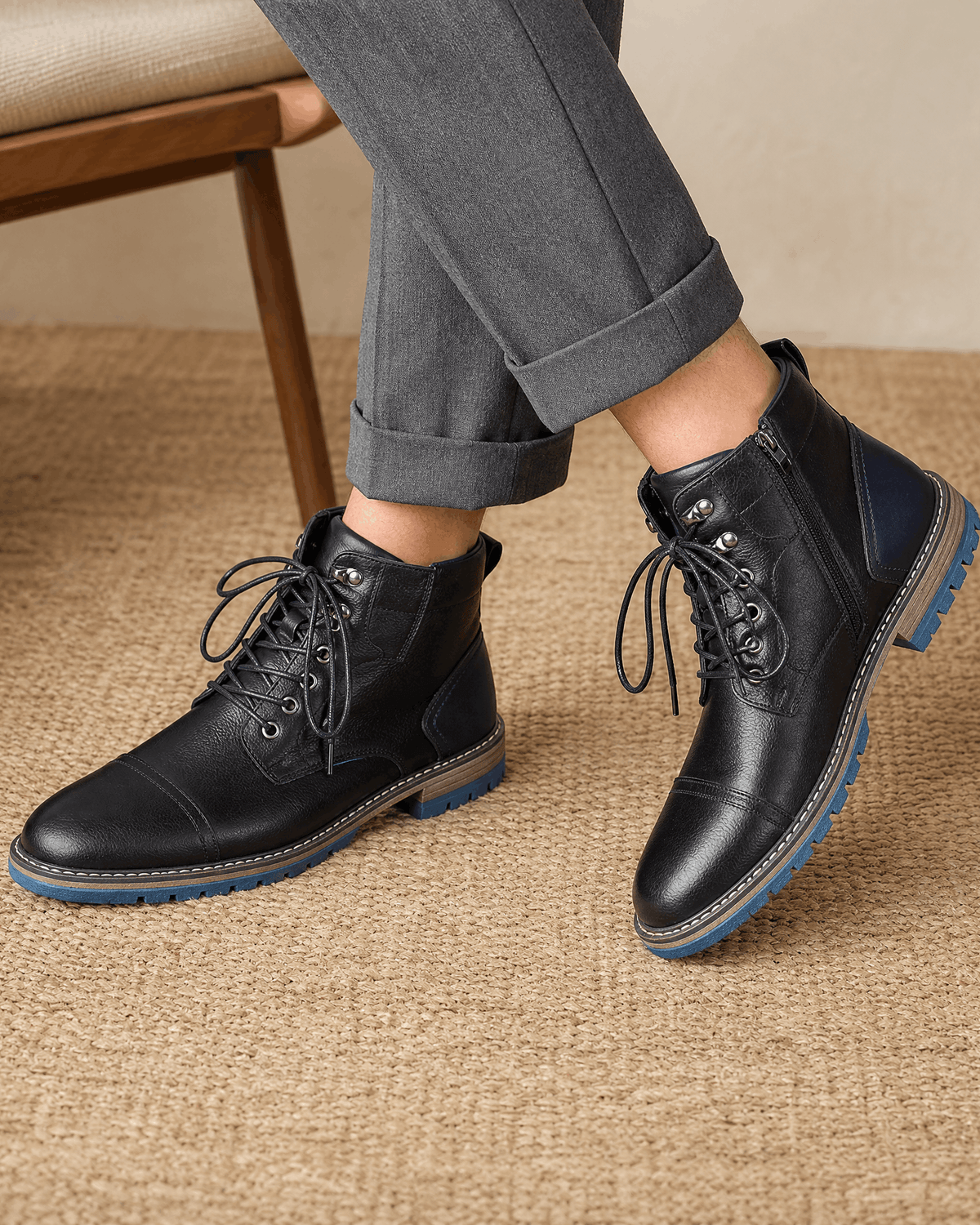 Black smooth grain leather cap toe boots with lace-up front, side zip, and a treaded blue lug outsole.