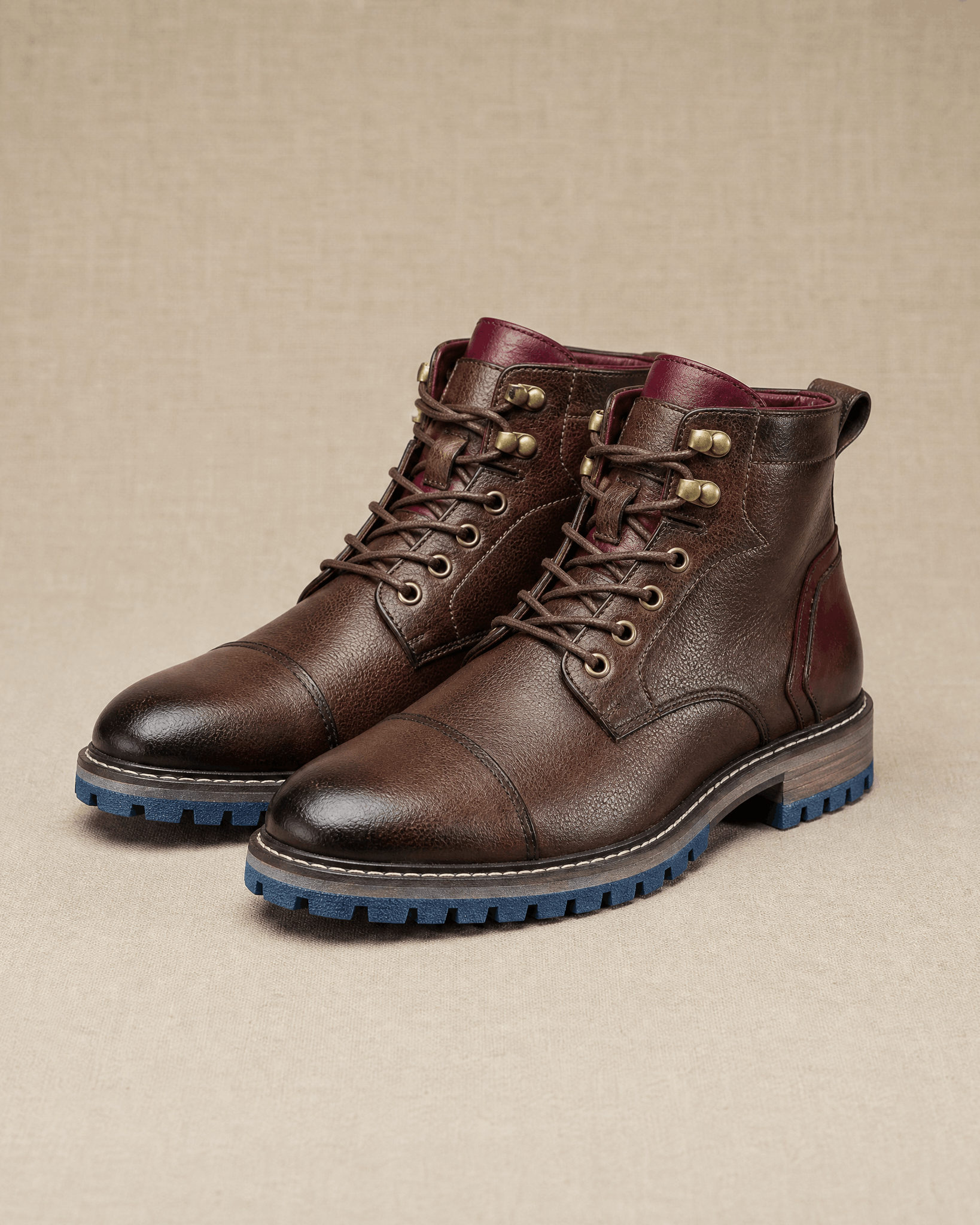 Dark brown smooth grain leather cap toe boots with lace-up front, side zip, and a blue lug rubber outsole.
