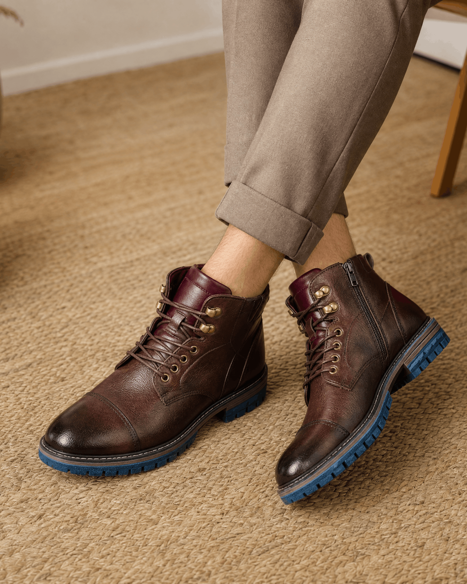 Dark brown smooth grain leather cap toe boots with side zips, hook lacing, and a contrasting blue lug rubber outsole.