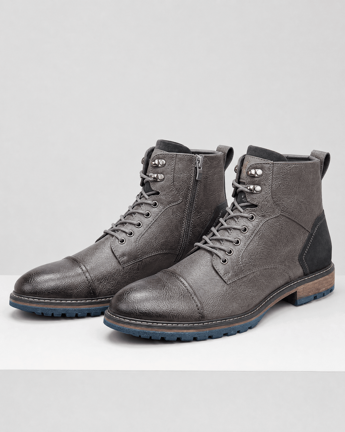 Gray smooth grain cap toe boots with lace-up front, side zip entry, and a durable lug rubber outsole.