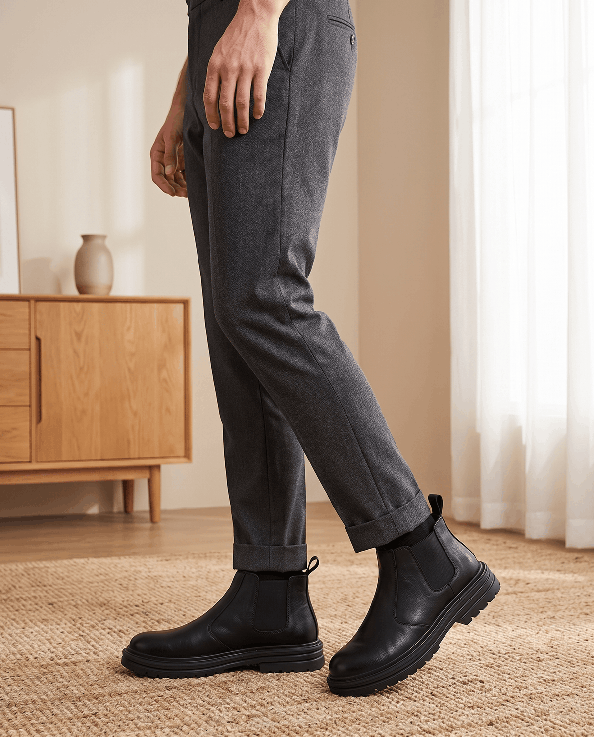 Black pebbled leather Chelsea boots with elastic side panels, twin pull tabs, and a chunky lugged platform sole.