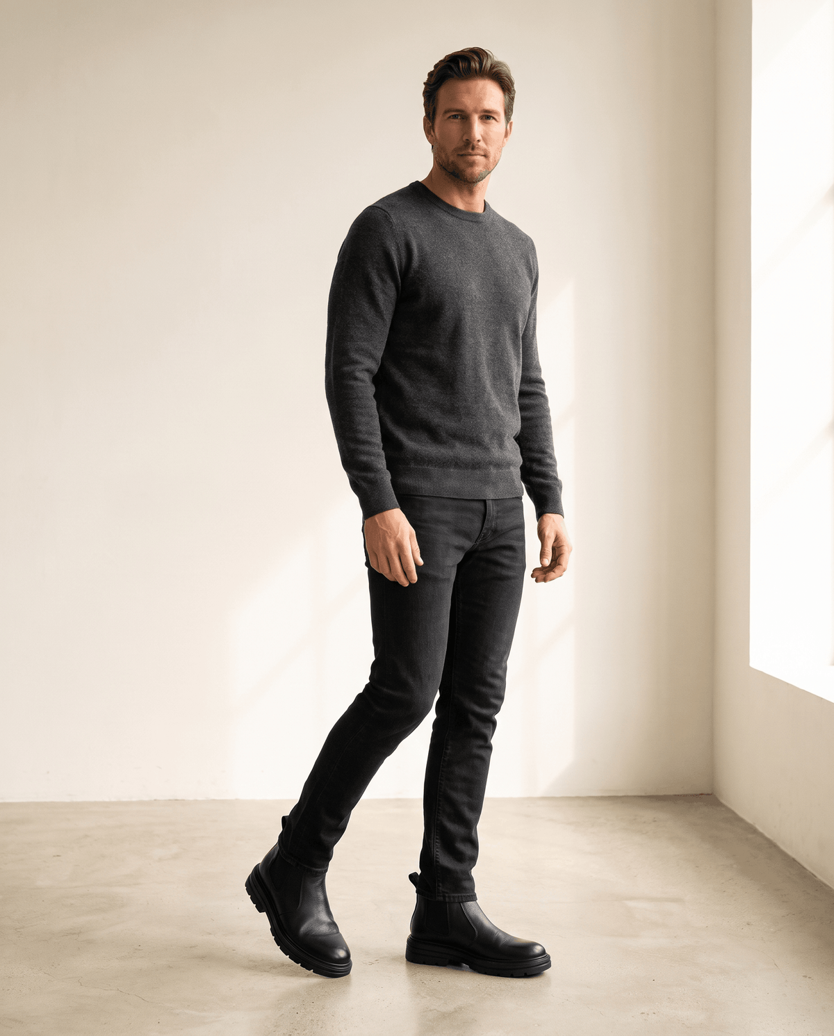 Black pebbled leather Chelsea boots featuring elastic side panels, twin pull tabs, and a chunky lugged platform sole.