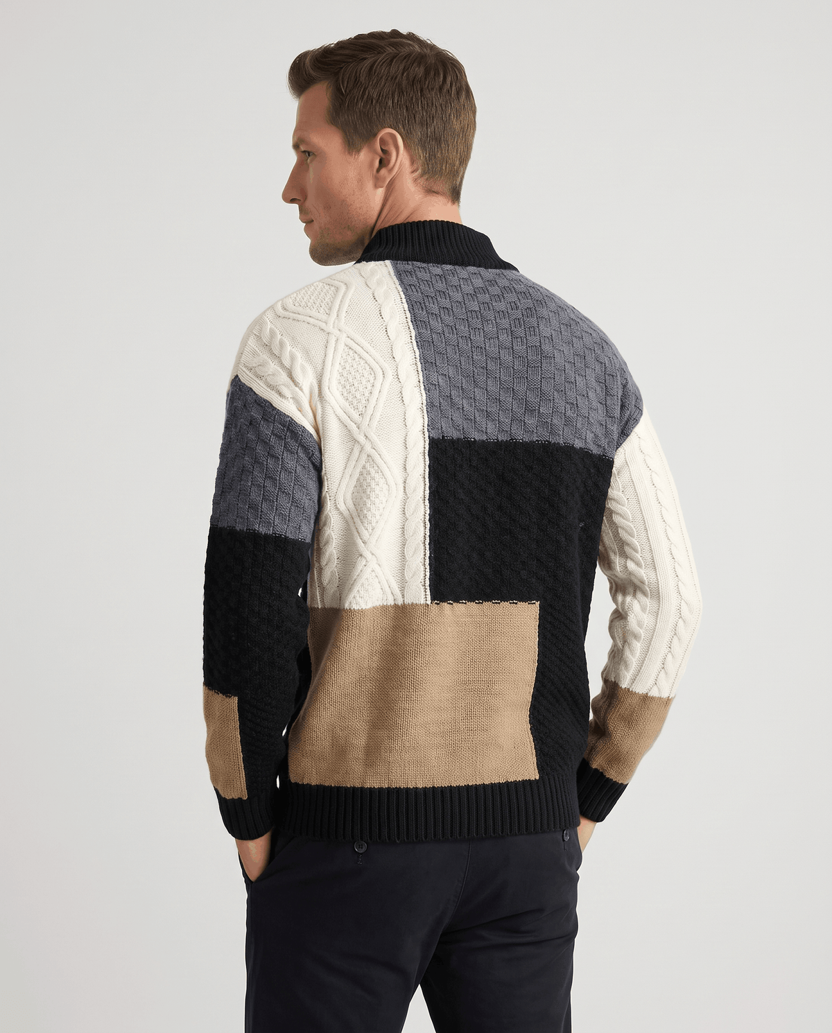 Back view of black colorblock sweater with cream and tan patchwork panels
