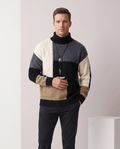 Man wearing men's colorblock mock neck sweater in black, cream, blue and tan
