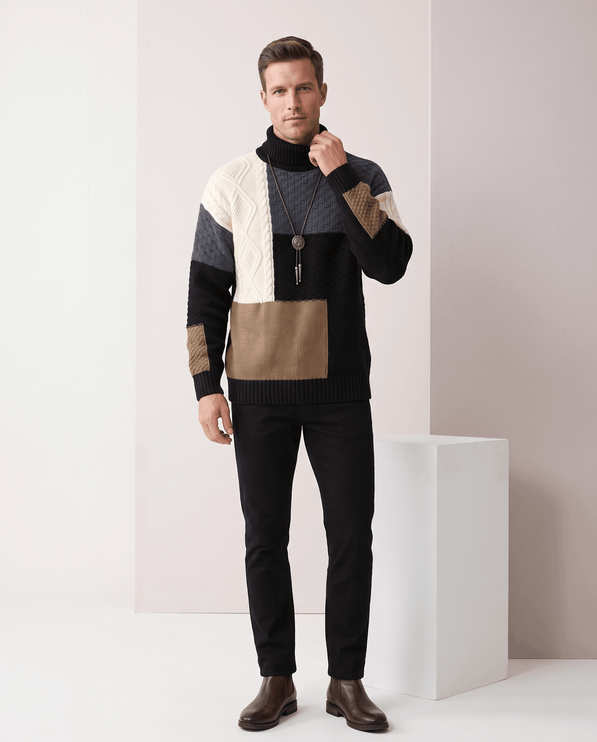 Full-length black colorblock sweater outfit with black trousers and brown boots