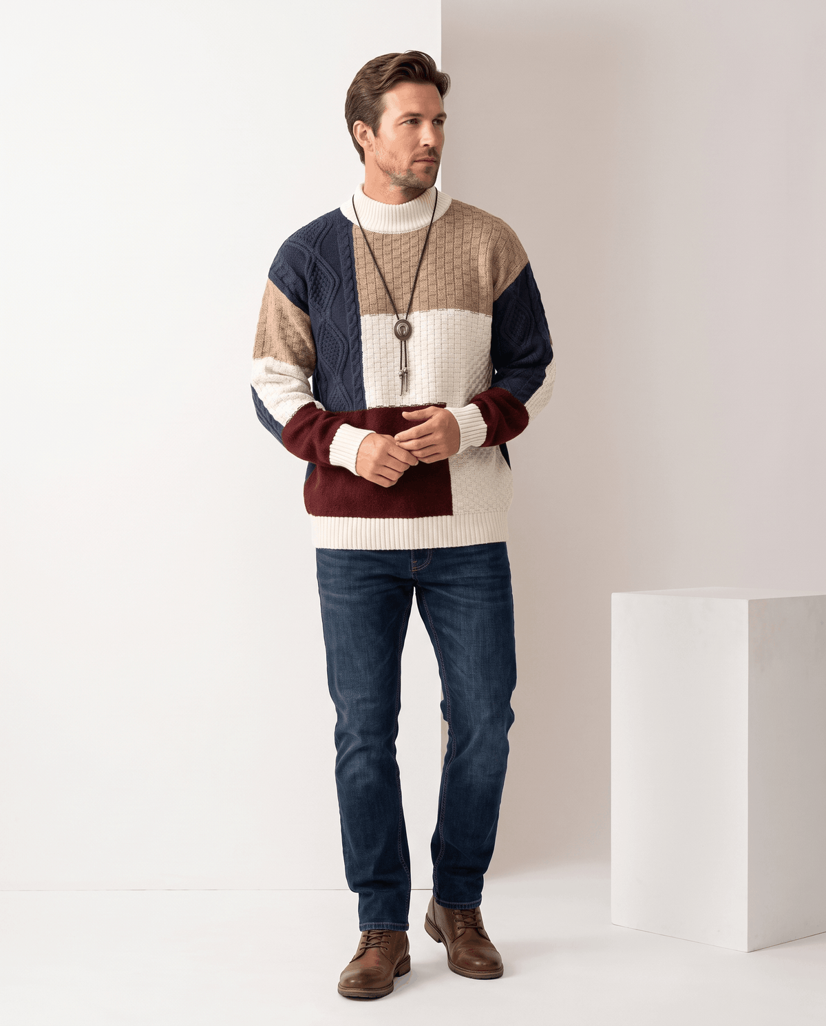 Full-length navy colorblock sweater look with blue jeans and brown boots