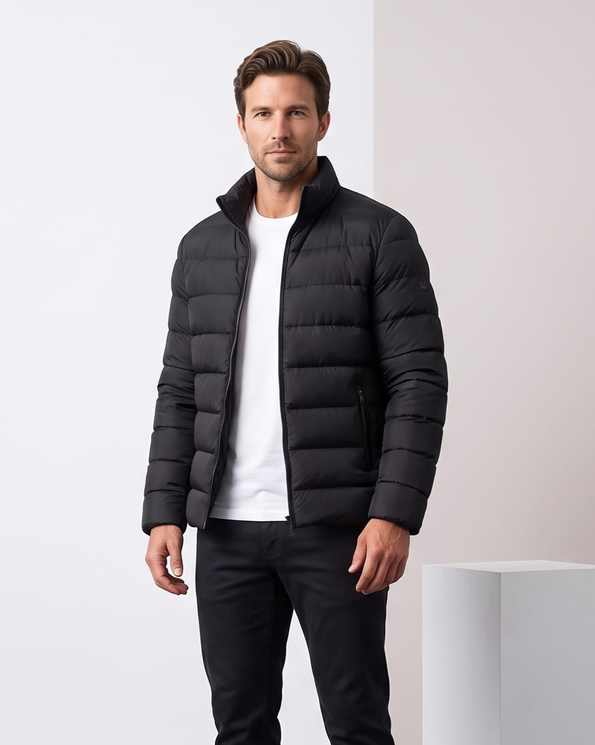 All-black colorway worn open, tonal zip and stand collar at the neck