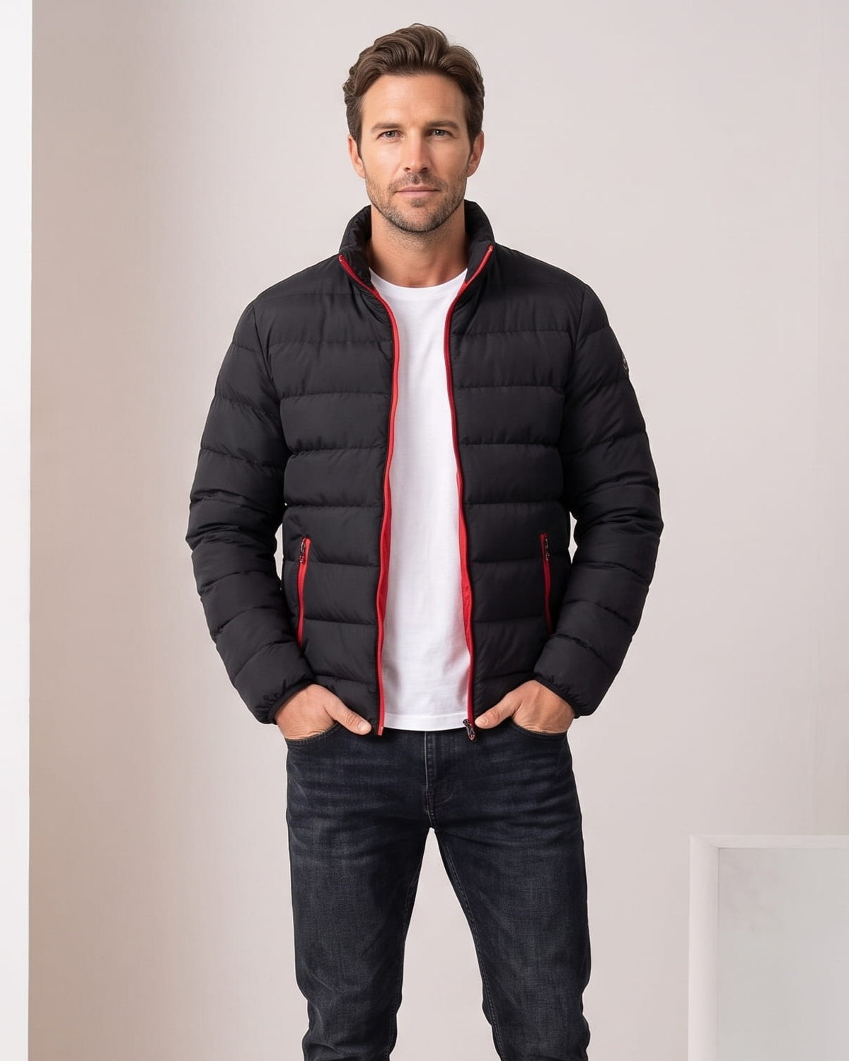 Black jacket with red zip tape and red pocket zips, worn open over white tee