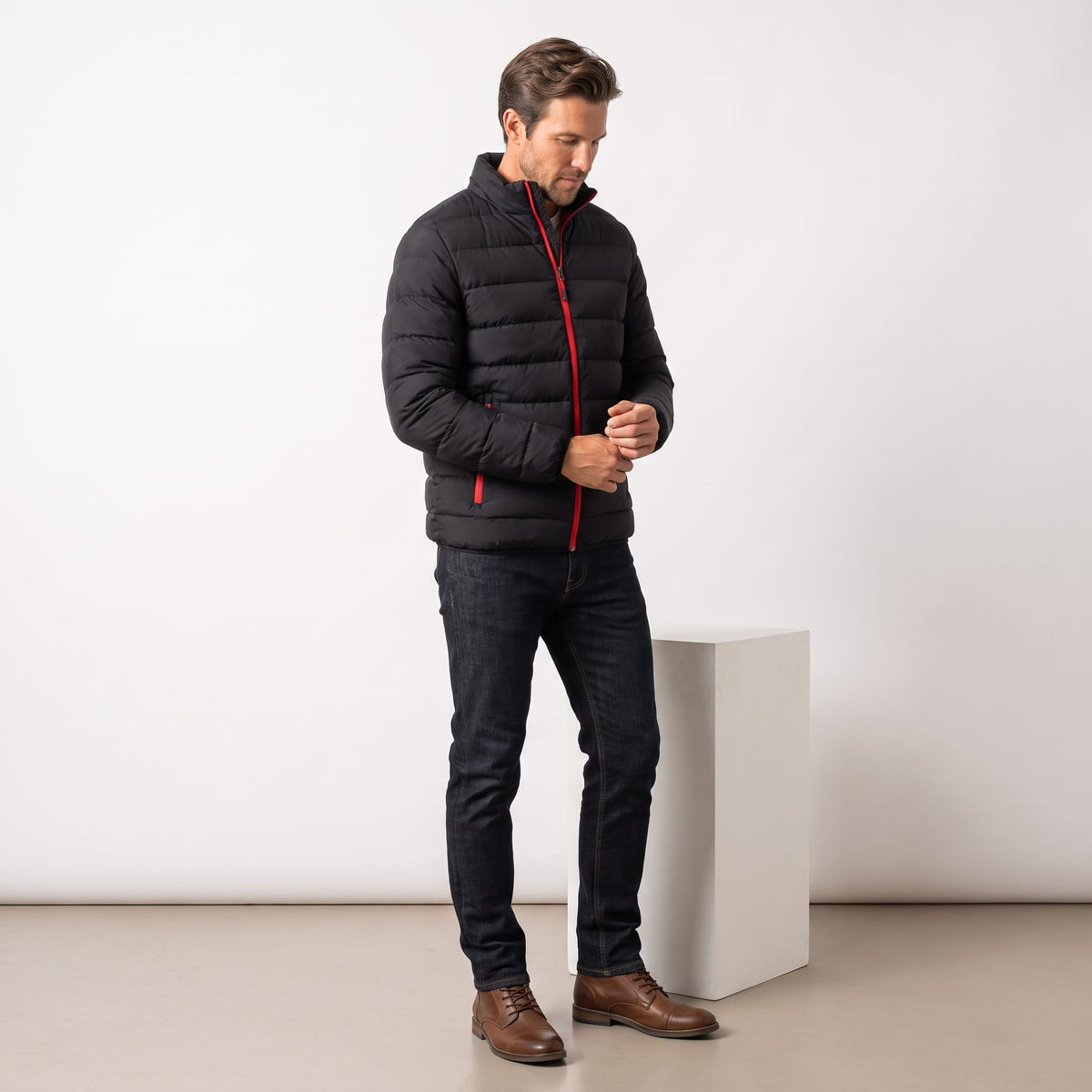 Black and red jacket styled full-length with dark jeans and brown boots
