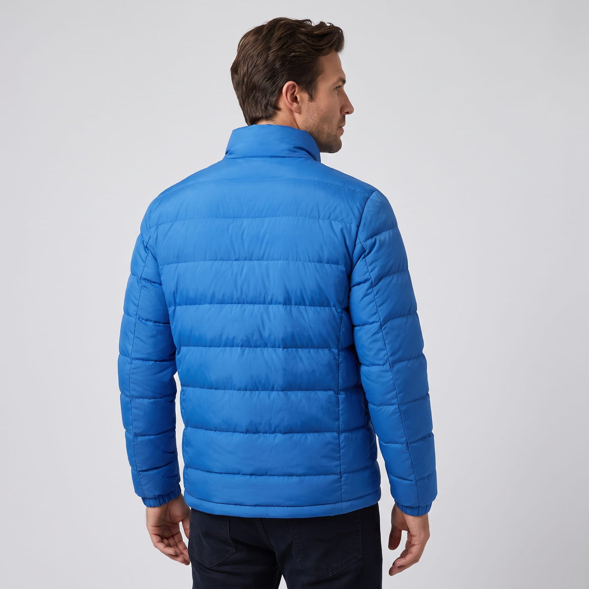 Back view in blue showing quilted channels running across the body