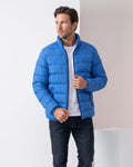 Man wearing blue contrast-zip puffer jacket with stand collar, adjusting the zip