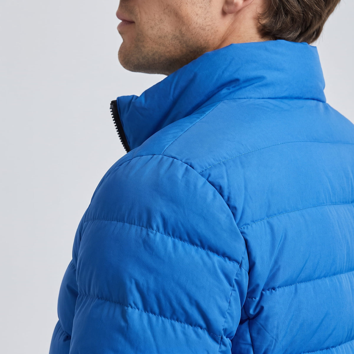 Shoulder and collar detail in blue, showing the matte shell and seam line