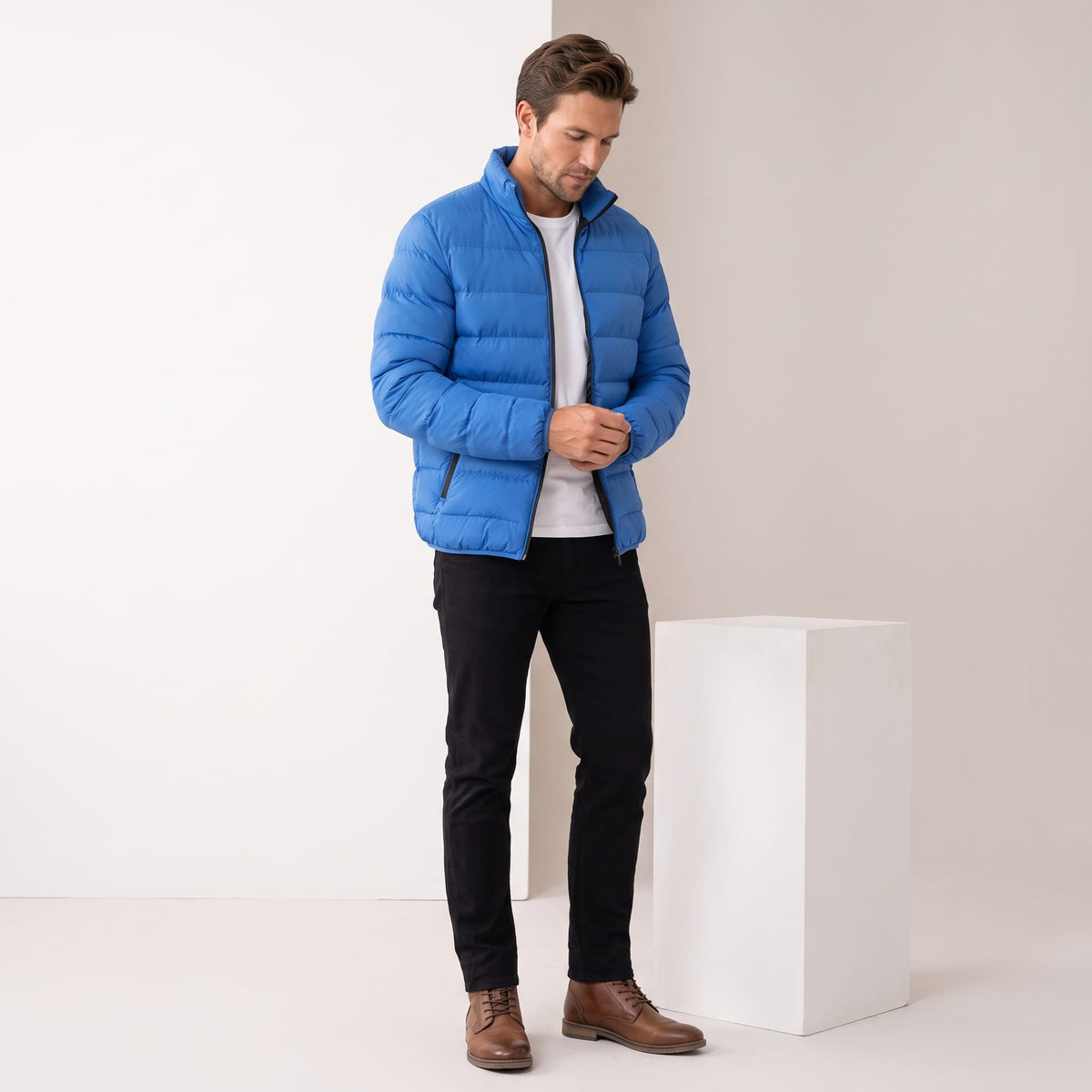 Blue jacket styled full-length with black jeans and brown leather boots