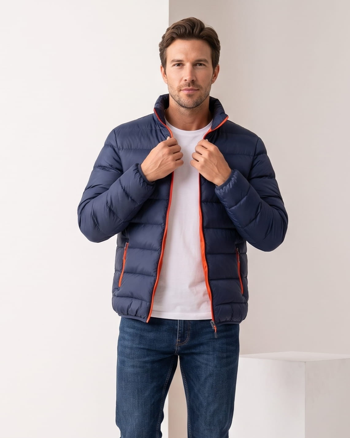 Navy jacket with orange zip trim, hands holding the collar open