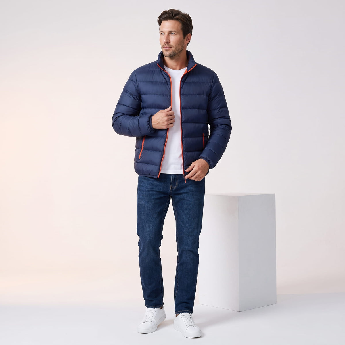 Navy jacket styled full-length with blue jeans and white sneakers
