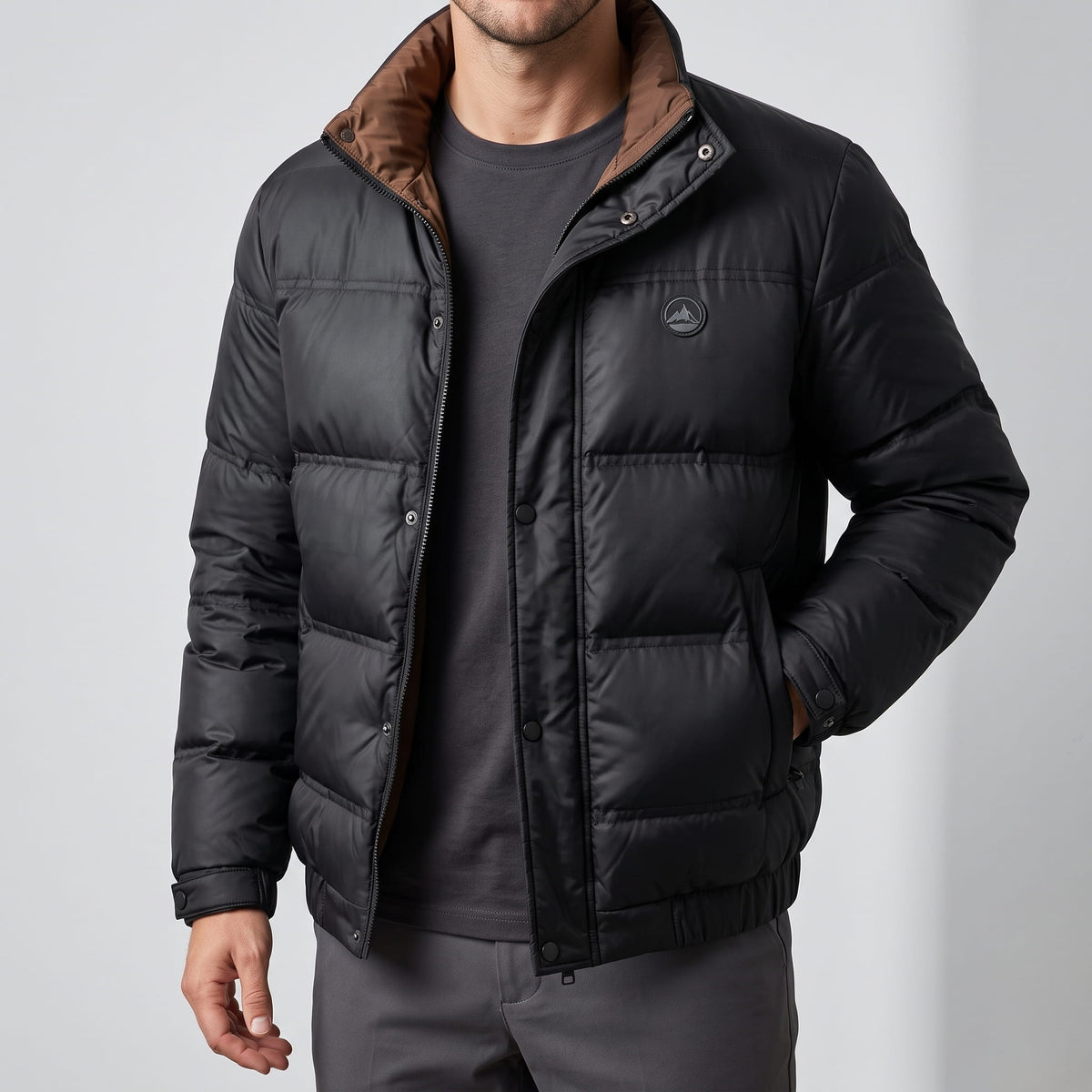 Black jacket torso showing snap placket, chest patch and side pocket