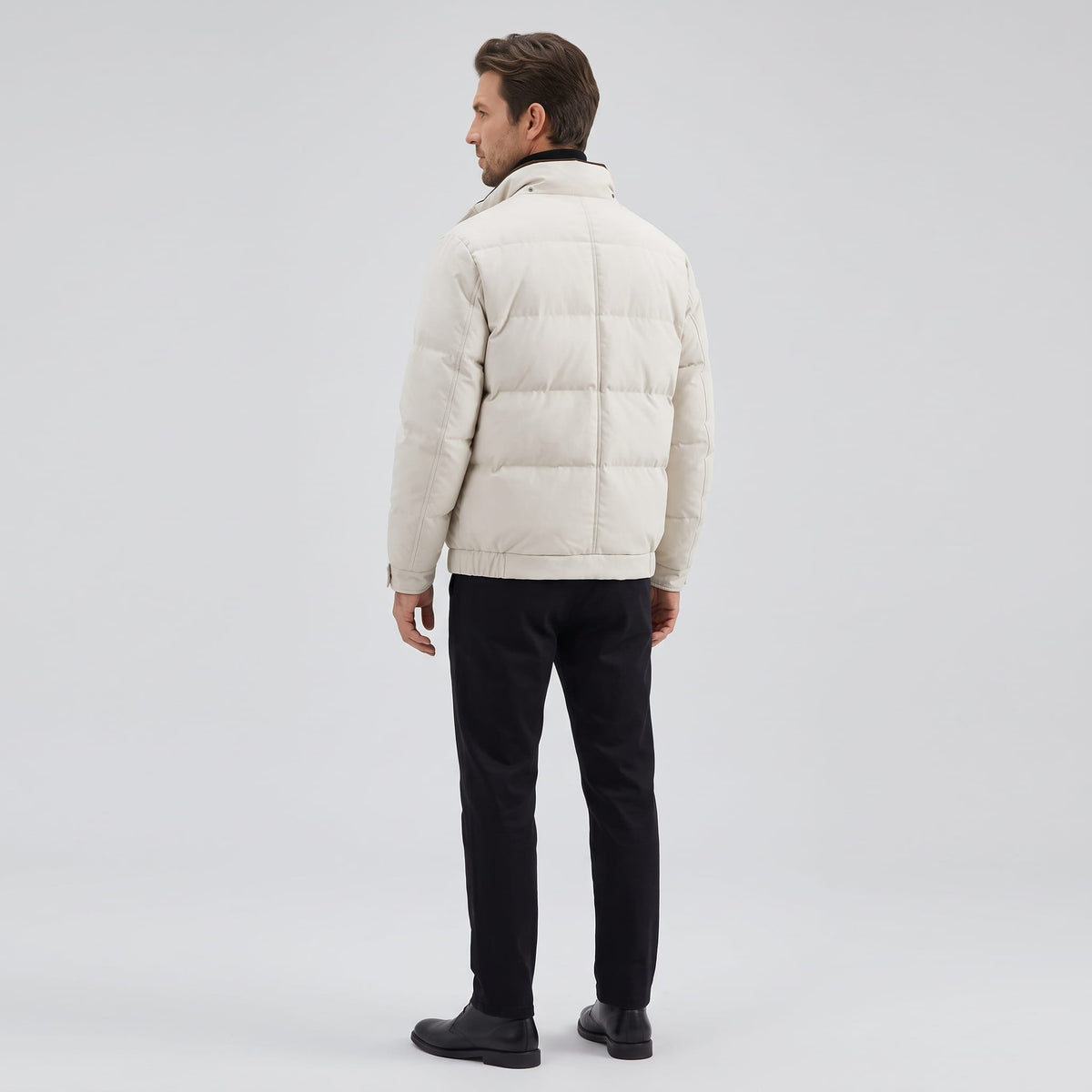 Back view of the cream jacket showing the pillowed quilting and hem