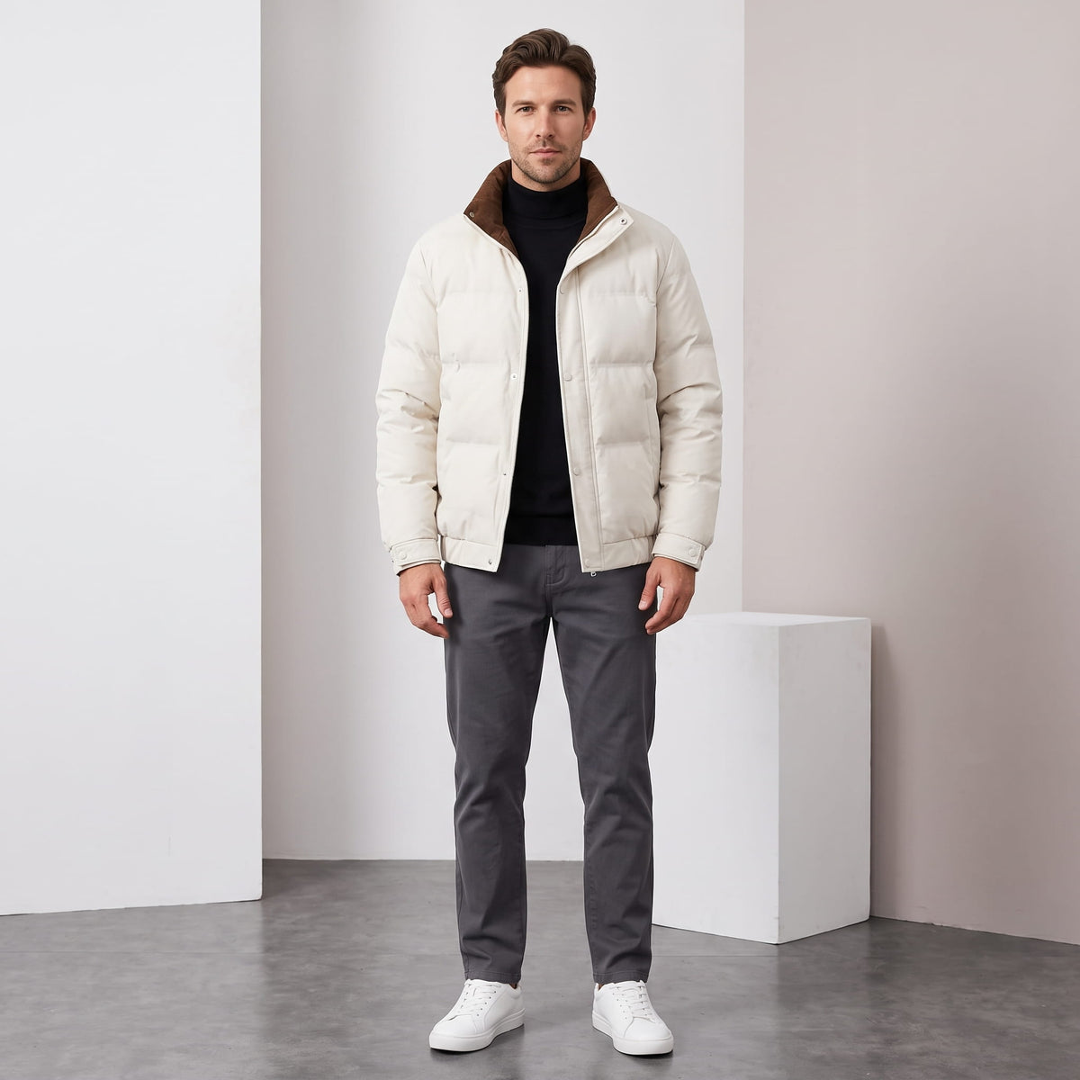 Cream jacket styled full-length with grey trousers and white sneakers
