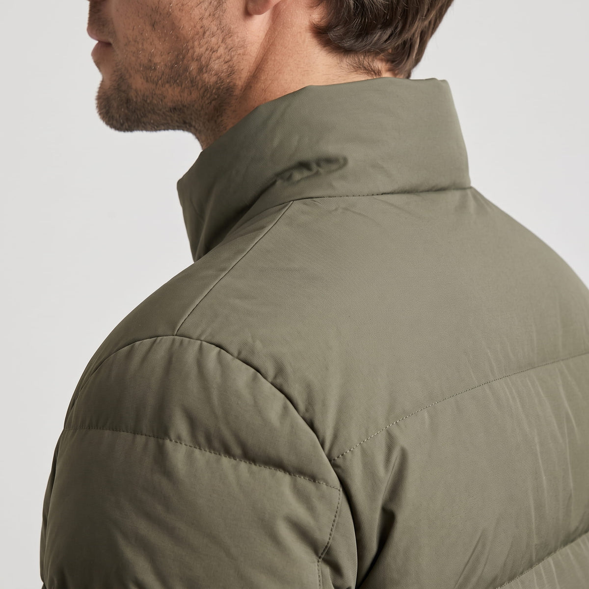 Close view of the olive shoulder and raised collar from behind