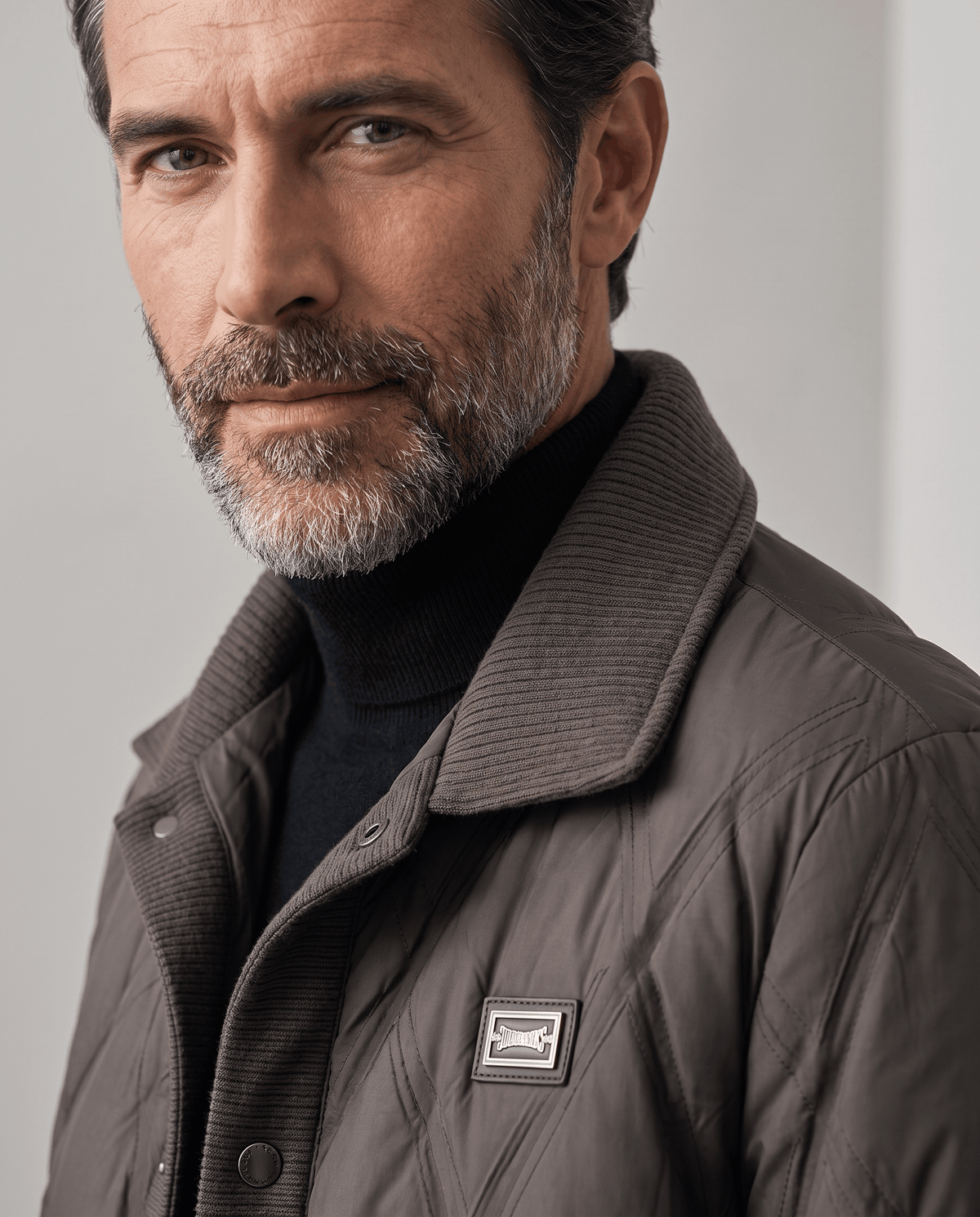 Close-up of the ribbed knit collar on a dark brown diamond quilted puffer jacket