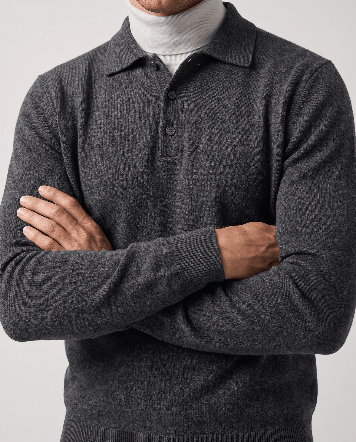 Man with arms crossed wearing the Elias dark gray wool knit polo sweater